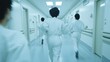 © isend - People in white protective suits run down a long hallway