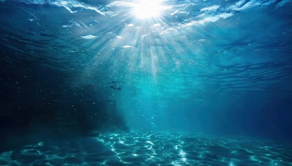 Poster - sunlit underwater ocean scene with sandy seabed, shimmering light rays, and a school of fish in the deep blue sea

