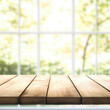 © Olya Fedorova - Empty wooden table for product advertising on window background