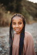 © Cavan Images - Multiracial black mixed race girl green eyes smiling in fields summer