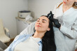 © Serhii - The doctor makes an injection into the head of a girl from hair loss. Hair treatment in a cosmetology clinic