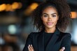 © Роман Варнава - Stylish black businesswoman exuding confidence in modern office environment with polished demeanor