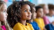 © Natawut - Focused Little Girl With Curly Hair Listening in Classroom Setting