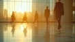 © KhaizanGraphic - Business people walking through a modern office building during sunset