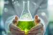 © vasyan_23 - Close-up of hands holding a green chemical solution in a glass flask