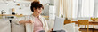 © LIGHTFIELD STUDIOS - Bright and cheerful young woman engages with her laptop in a cozy home setting