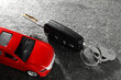 © New Africa - Car key and model on grey textured table, closeup. Buying auto