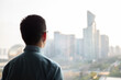 © zhu difeng - rear  view asian man look at city