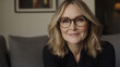 © MashMash - Confident middle-aged blonde woman with glasses smiling in a modern home interior, natural lighting, warm atmosphere, professional portrait for business, lifestyle, and personal branding