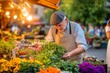 © Serjio - Mercado de flores en el atardecer, un hombre mayor cultivando su independencia financiera con dedicación