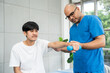 © Chanakon - Physical therapy. Male Nurse aids young man in recovering from spine injury and providing orthopedic massage Orthopedic healthcare and chiropractor with person for physical therapy rehabilitation