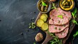 © somsri - A rustic wooden board with slices of pt en crote, served with pickles and mustard.