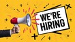 © CreativeSummo - We Are Hiring' join our team.  A bold, red  sign held up by a hand, with a megaphone blasting out the message. splatter effect, ideal for recruitment, job search, new opportunities.
