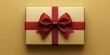 © Georg - Beautifully wrapped gift box with a red ribbon on a golden background, perfect for celebration or special occasion