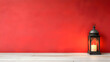 © Dibani - Illuminated lantern on white wood against red wall; space for text; holiday, celebration, or spiritual setting
