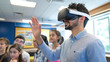 © ЮРИЙ ПОЗДНИКОВ - Teacher using virtual reality headset in classroom with students watching