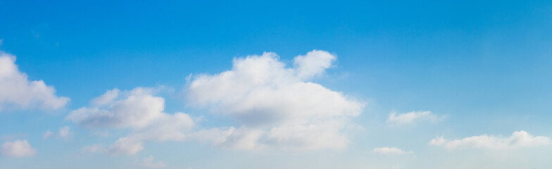 blue sky with fluffy white clouds in sunny weather