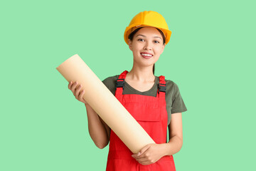 Wall Mural - female asian decorator with wallpaper roll on green background