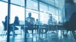 © kkkiim graphic - Blurred photograph of a business leader guiding their team during a morning meeting in a modern office