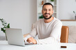 © Pixel-Shot - Handsome man working with laptop at home