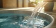 © AndiAzis - Water Pouring into a Teal Hot Tub