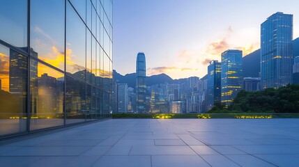 Aufkleber - Urban skyline at sunset with reflective glass buildings and mountains in the background.