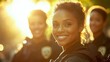 © MKS - Three smiling black female police officers are in the foreground of a close-up shot, with a male officer behind them, all dressed in dark blue uniforms and smiling at the camera