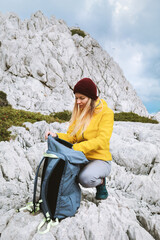 Wall Mural - woman packing her backpack in mountains travel solo girl hiking in greece active adventure lifestyle