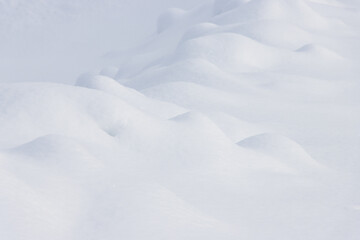 Wall Mural - small mounds of white snow abstract winter landscape background