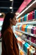 © chelmicky - Woman choosing hair products in supermarket shelf, reading label information