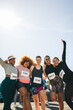 © Jacob Lund - Group of female friends celebrate after finishing a 5km race