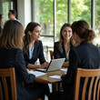© Javier - Professional women collaborating and discussing business strategies.