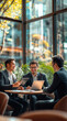 © Javier - Three businessmen discussing work at a modern cafe, using laptops and tablets.