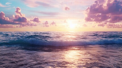 Wall Mural - Waves gently lap against the shore as a vibrant sunset paints the sky in shades of pink and orange. Clouds scatter above, enhancing the tranquil atmosphere at the beach