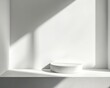 © Alena - A white pedestal stands alone in a white room