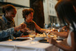 © bernardbodo - Friends enjoying dinner together at a restaurant