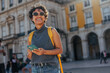 © bernardbodo - Young tourist using smart phone and smiling in lisbon, portugal