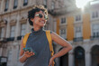 © bernardbodo - Tourist with backpack and smart phone exploring european city