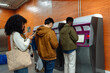 © bernardbodo - People using self-service ticketing machine in subway station
