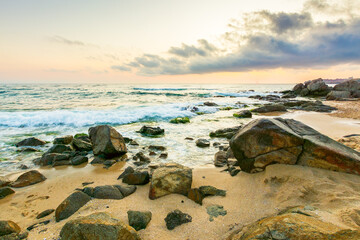Wall Mural - summer vacation landscape at the beach. dramatic seascape at sunrise. calm wave washing the coast wi