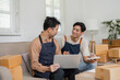 © wichayada - Small business partners discussing strategy while preparing packages at home office