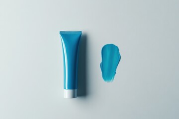 Poster - Bright turquoise cream tube and a swatch on light background showcasing color and texture for artistic projects