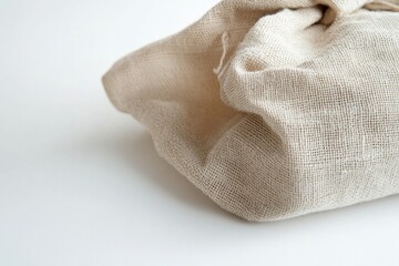 Poster - Sack made of natural fabric resting on a clean, white surface interior shot capturing minimalist design aesthetics