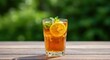 © Katsyarina - Iced tea glass with lemon and mint on wooden table, outdoor concept. Refreshment drink for summer, National Iced Tea Day. Copy space for text.