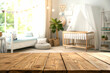 © Payel - A high-angle, close-up view of a light brown wooden tabletop, perfect for product placement or showcasing a baby-themed item.