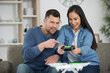 © auremar - young couple playing video game together at home