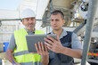 © auremar - two builders analyzing a tablet