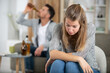 © auremar - man pouring alcohol and woman sitting upset