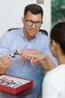 © auremar - optician discussing choice of eyeglasses with client