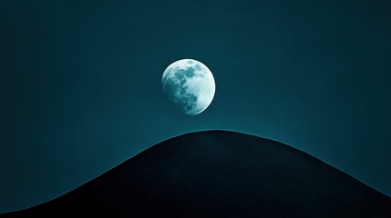 Wall Mural - a full moon rises over a dark blue sky, casting a shadow on the hill below while the foreground rema